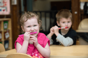 Children brushing their teeth in the classroom