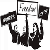 Three women holding up signs that together read "Women's Freedom Center"