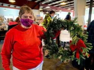 Staff member displays her finished wreath