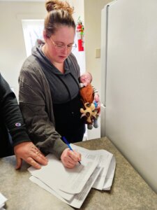 A woman filling out housing application forms