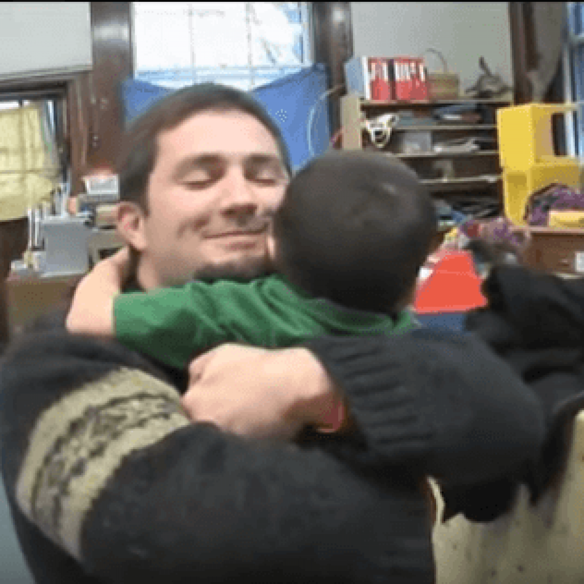 A screen capture from the Engaging Fathers video of a father embracing a child.